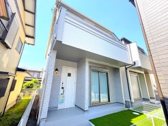 青空の下、清潔感あふれる佇まいが印象的。爽やかな緑が広がるエントランスは、穏やかな日常を予感させます
